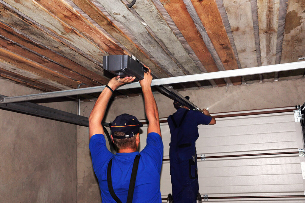 Technicians installing a new garage door opener system