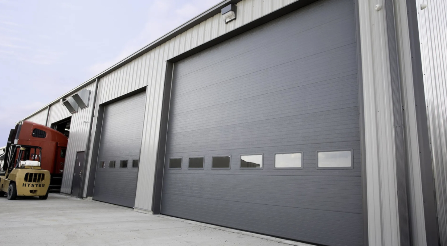 Large industrial garage door with gray metal exterior